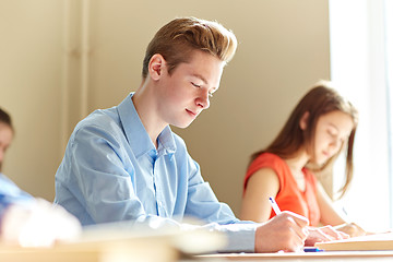 Image showing group of students with books writing school test