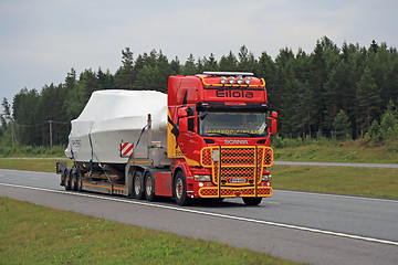 Image showing Colorful Scania R560 Hauls Boat along Motorway