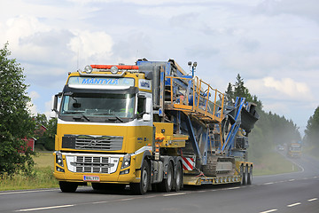 Image showing Volvo FH Transports Construction Machinery along Highway