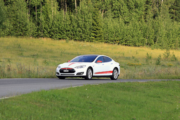 Image showing Tesla Model S Electric Car and Green Rural Road