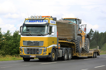 Image showing Volvo FH16 Semi Hauls CAT Wheel Loader