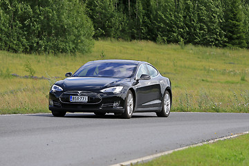 Image showing Black Tesla Model S Electric Car on Green Rural Road