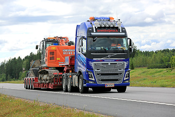 Image showing Volvo FH16 Semi Hauls Hitachi Tracked Excavator 