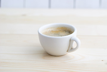 Image showing Cup of coffee on wooden table