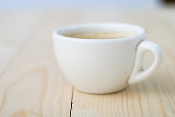 Image showing Cup of coffee on wooden table