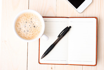 Image showing Smartphone with notebook and cup of strong coffee