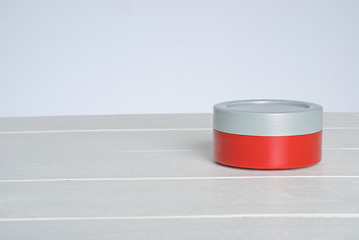 Image showing tib of face cream with red cover