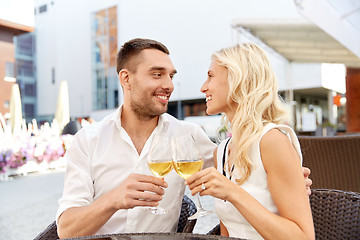 Image showing happy couple drinking wine at open-air restaurant