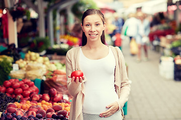 Image showing pregnant woman choosing food at street market