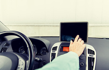 Image showing close up of young man with tablet pc driving car