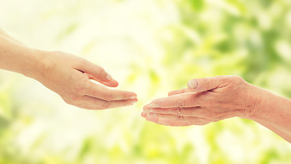 Image showing close up of senior and young woman hands