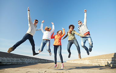 Image showing smiling friends in sunglasses laughing on street