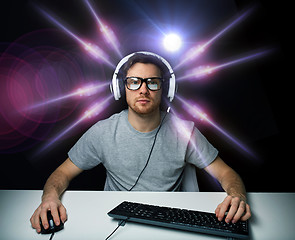 Image showing man in headset playing computer video game