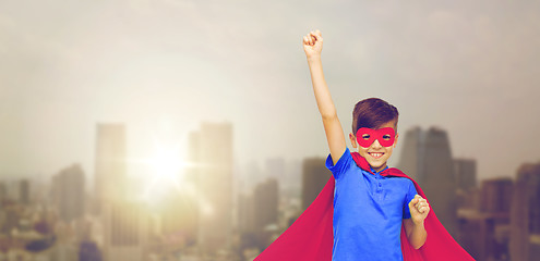 Image showing boy in red superhero cape and mask showing fists