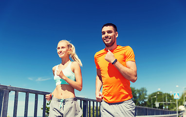 Image showing smiling couple running at summer seaside