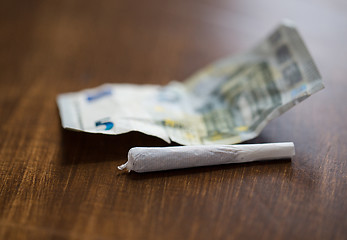 Image showing close up of marijuana joint and money