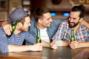 Image showing happy male friends drinking beer at bar or pub