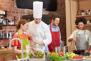 Image showing happy friends and chef cook cooking in kitchen