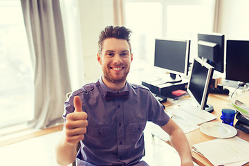 Image showing happy male office worker showing thumbs up