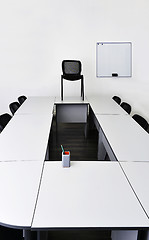 Image showing Empty meeting room in the office with tables and chairs