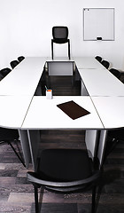 Image showing Empty meeting room in the office with tables and chairs