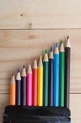 Image showing Colored pencils on a wooden board