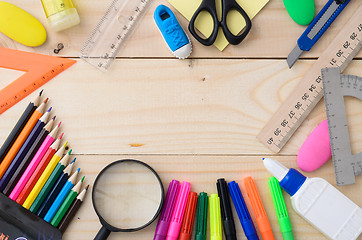 Image showing School stationery on wooden board