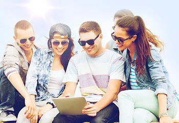 Image showing group of teenagers looking at tablet pc