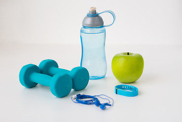 Image showing dumbbells, fitness tracker, earphones and bottle