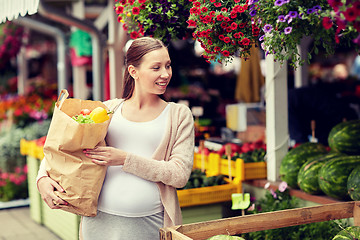 Image showing pregnant woman with bag of food at street market