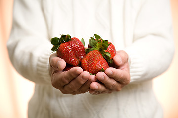 Image showing Holding strawberries