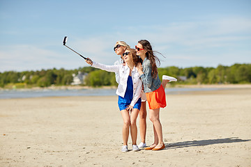 Image showing group of smiling women taking selfie on beach