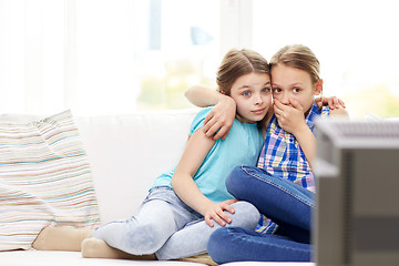 Image showing scared little girls watching horror on tv at home