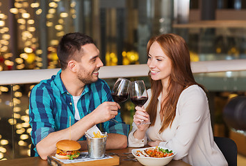 Image showing happy couple dining and drink wine at restaurant