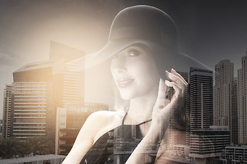 Image showing beautiful woman in black hat over dark background