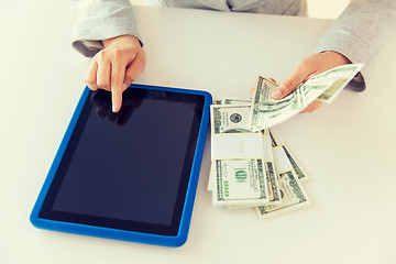 Image showing close up of woman hands with tablet pc and money