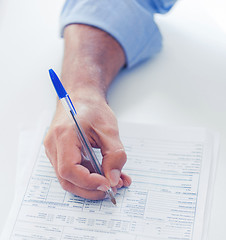 Image showing man filling tax form