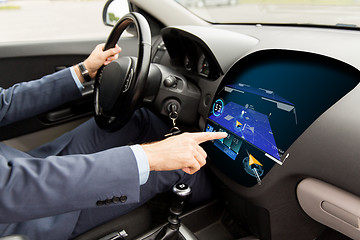 Image showing close up of man driving car with gps navigator map