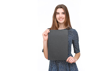 Image showing Young smiling woman show blank card or paper