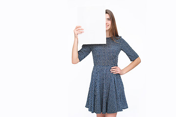 Image showing Young smiling woman show blank card or paper