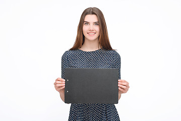 Image showing Young smiling woman show blank card or paper