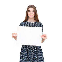 Image showing Young smiling woman show blank card or paper