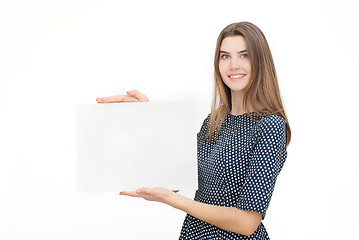 Image showing Young smiling woman show blank card or paper