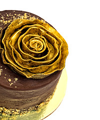 Image showing Chocolate Cake Sprinkled with Crumbs and Golden Rose
