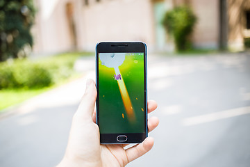 Image showing Moscow, Russia - August, 02: Android user play in Pokemon Go augmented reality mobile game on smartphone.