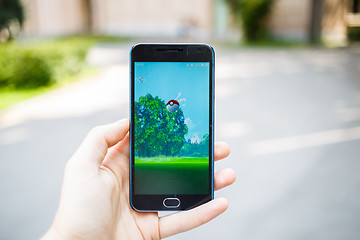 Image showing Moscow, Russia - August, 02: Android user play in Pokemon Go augmented reality mobile game on smartphone.