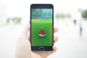 Image showing Moscow, Russia - August, 02: Android user play in Pokemon Go augmented reality mobile game on smartphone.