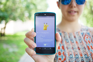 Image showing Moscow, Russia - August, 02: Android user play in Pokemon Go augmented reality mobile game on smartphone.