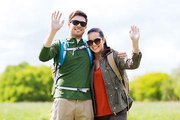 Image showing happy couple with backpacks hiking outdoors