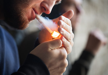 Image showing close up of young people smoking cigarette